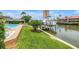 Backyard with lush grass and canal access, perfect for outdoor activities and waterfront enjoyment at 4935 58Th S Ave, St Petersburg, FL 33715