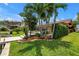 Backyard view showcasing the landscaped lawn, palm trees, and waterfront location at 4935 58Th S Ave, St Petersburg, FL 33715