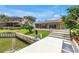 Stunning backyard view showcasing dock, lush lawn, and inviting pool with multiple patio doors at 4935 58Th S Ave, St Petersburg, FL 33715