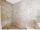 Detailed tile work shower with glass doors and marble accents at 4935 58Th S Ave, St Petersburg, FL 33715