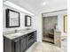 Bright bathroom featuring double sinks, tiled shower, and travertine flooring at 4935 58Th S Ave, St Petersburg, FL 33715