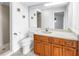 Well-lit bathroom with cherry cabinets, solid-surface countertop, and shower access at 4935 58Th S Ave, St Petersburg, FL 33715
