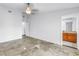 Minimalist bedroom featuring tile floors, a ceiling fan, and a view into the bath at 4935 58Th S Ave, St Petersburg, FL 33715