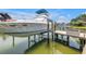 Close-up of boat lift and boat at dock on the property's waterfront at 4935 58Th S Ave, St Petersburg, FL 33715