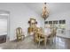 Elegant dining room featuring a chandelier and a large window with natural light and neutral colors at 4935 58Th S Ave, St Petersburg, FL 33715