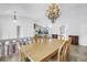 Open dining area with chandelier, connects to the living room with stone fireplace feature at 4935 58Th S Ave, St Petersburg, FL 33715