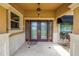 Close-up of double door home entrance with decorative columns and manicured plants at 4935 58Th S Ave, St Petersburg, FL 33715