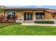 Elegant home entrance with double doors, manicured lawn, and decorative plantings at 4935 58Th S Ave, St Petersburg, FL 33715