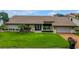 Beautiful exterior view of the home with a large well-manicured lawn, a covered entry, and garage at 4935 58Th S Ave, St Petersburg, FL 33715