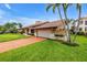 Beautiful home with a tile roof, lush lawn, and a brick driveway at 4935 58Th S Ave, St Petersburg, FL 33715