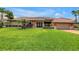 Beautiful exterior view of the home with a large well-manicured lawn, a covered entry, and garage at 4935 58Th S Ave, St Petersburg, FL 33715