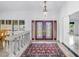 Inviting foyer with decorative glass doors, chandelier, and a beautiful rug that complements the stone flooring at 4935 58Th S Ave, St Petersburg, FL 33715