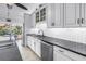 Modern kitchen featuring stainless steel dishwasher, subway backsplash, and granite countertops at 4935 58Th S Ave, St Petersburg, FL 33715