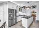 Bright kitchen featuring stainless steel refrigerator, white cabinetry, and granite countertops at 4935 58Th S Ave, St Petersburg, FL 33715
