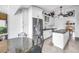 Modern kitchen with stainless steel refrigerator, white cabinetry, and a center island with bar seating at 4935 58Th S Ave, St Petersburg, FL 33715