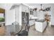 Bright kitchen with white cabinets, granite countertops, stainless steel appliances and a center island at 4935 58Th S Ave, St Petersburg, FL 33715
