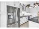 Spacious kitchen featuring stainless steel appliances, white cabinetry, and granite countertops at 4935 58Th S Ave, St Petersburg, FL 33715