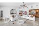Open-concept living room featuring a large sectional sofa, tile flooring, and views of the kitchen and dining area at 4935 58Th S Ave, St Petersburg, FL 33715
