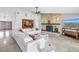 Open living room with a stone fireplace, large sectional sofa, and views of the front entrance and waterfront at 4935 58Th S Ave, St Petersburg, FL 33715