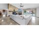 Spacious living room with a stone fireplace, modern sofa, and sliding doors leading to the pool area at 4935 58Th S Ave, St Petersburg, FL 33715