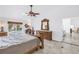 Comfortable main bedroom featuring travertine floors, decorative wood furniture, and a view of the pool at 4935 58Th S Ave, St Petersburg, FL 33715