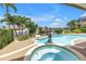 Aerial view of pool and patio with views of the canal, a mermaid statue, and lush tropical landscaping at 4935 58Th S Ave, St Petersburg, FL 33715