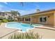 Backyard pool and patio area with a view of the home's exterior at 4935 58Th S Ave, St Petersburg, FL 33715