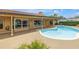Backyard view features a pristine pool, ideal for leisurely swims and enjoying the sunny outdoors at 4935 58Th S Ave, St Petersburg, FL 33715