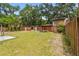 Statues and mature trees decorate a backyard with fencing at 5306 Downing St, Dover, FL 33527