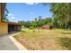 The backyard view features mature trees and a storage shed at 5306 Downing St, Dover, FL 33527