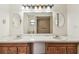 Spacious bathroom with double sink, overhead lighting and a partially visible shower at 5306 Downing St, Dover, FL 33527