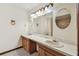 Bathroom with double sink, and a shower and toilet in the background at 5306 Downing St, Dover, FL 33527
