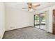 Spacious bedroom with ceiling fan, sliding glass door and a view of the back yard at 5306 Downing St, Dover, FL 33527