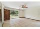 Bedroom with a view to the back yard through a sliding glass door; ceiling fan above at 5306 Downing St, Dover, FL 33527