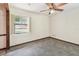 Bedroom with a ceiling fan and a partially visible window overlooking the side yard at 5306 Downing St, Dover, FL 33527