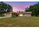 A charming home with stone accents and attached garage, set against a colorful sky at 5306 Downing St, Dover, FL 33527
