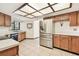 Spacious kitchen with stainless steel refrigerator and a unique paneled lighting fixture on the ceiling at 5306 Downing St, Dover, FL 33527