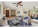 Cozy living room featuring stylish furniture, including a couch, chairs, and a glass coffee table at 5306 Downing St, Dover, FL 33527