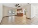 Open-plan living and dining area with a view into the kitchen with stainless steel refrigerator at 5306 Downing St, Dover, FL 33527