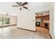 Large living space with tile flooring, open to the kitchen, featuring wooden cabinets and appliances at 5306 Downing St, Dover, FL 33527