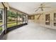 The screened porch offers a beautiful view of the back yard and includes a ceiling fan at 5306 Downing St, Dover, FL 33527