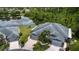 Aerial view showcasing lush backyard, waterfront location, and the home's expansive roof at 542 Princeton Greens Ct # 21, Sun City Center, FL 33573