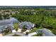 Aerial view showcasing lush backyard, waterfront location, and the home's neighborhood at 542 Princeton Greens Ct # 21, Sun City Center, FL 33573