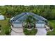 Aerial view of home highlighting its landscaping, symmetrical design, and lush surroundings at 542 Princeton Greens Ct # 21, Sun City Center, FL 33573
