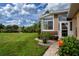 Serene backyard with lush greenery and pond view, as seen from the side of the home at 542 Princeton Greens Ct # 21, Sun City Center, FL 33573