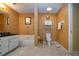 Well-kept bathroom with a toilet, tub and vanity with neutral colored tile and dark countertops at 542 Princeton Greens Ct # 21, Sun City Center, FL 33573