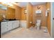 Well-maintained bathroom with a toilet, tub and vanity with neutral colored tile at 542 Princeton Greens Ct # 21, Sun City Center, FL 33573