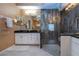 Beautifully appointed bathroom with glass enclosed shower, black countertop, and vanity at 542 Princeton Greens Ct # 21, Sun City Center, FL 33573
