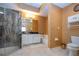 A bathroom featuring a glass shower, toilet, and vanity with neutral colored tile at 542 Princeton Greens Ct # 21, Sun City Center, FL 33573