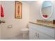 Clean bathroom with granite countertop and white vanity cabinets for storage at 542 Princeton Greens Ct # 21, Sun City Center, FL 33573